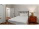 Inviting bedroom with a bed, a nightstand, and wood flooring at 4986 Salt Creek Ct., North Myrtle Beach, SC 29582