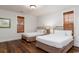 This bedroom features two twin beds with beautiful wood laminate flooring and natural light at 4986 Salt Creek Ct., North Myrtle Beach, SC 29582