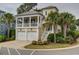 Charming yellow two-story home with a brick driveway and lush tropical landscaping at 4986 Salt Creek Ct., North Myrtle Beach, SC 29582