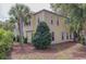 Charming two-story home with a yellow exterior and lush landscaping at 4986 Salt Creek Ct., North Myrtle Beach, SC 29582