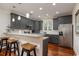 Modern kitchen with stainless steel appliances, a breakfast bar, and dark grey cabinetry at 4986 Salt Creek Ct., North Myrtle Beach, SC 29582