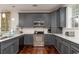Contemporary kitchen featuring dark grey cabinets, stainless steel appliances, and ample counter space at 4986 Salt Creek Ct., North Myrtle Beach, SC 29582