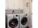 Bright laundry room with front load washer and dryer and white cabinetry at 4986 Salt Creek Ct., North Myrtle Beach, SC 29582