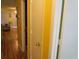 Hallway featuring laminate flooring, yellow walls and doorways to the living areas at 500 Fairway Village Dr. # 4-F, Myrtle Beach, SC 29588