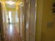 Hallway with closet space, laminate flooring, and bright yellow painted walls at 500 Fairway Village Dr. # 4-F, Myrtle Beach, SC 29588
