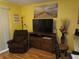 Comfortable living area with a recliner, entertainment center, and beach-themed decor, creating a relaxing vibe at 500 Fairway Village Dr. # 4-F, Myrtle Beach, SC 29588