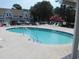 Community pool area featuring refreshing clear water and lounge chairs with the residences in the background at 500 Fairway Village Dr. # 4-F, Myrtle Beach, SC 29588