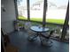 Enclosed back porch with outdoor furniture, providing a private and comfortable seating area overlooking the yard at 500 Fairway Village Dr. # 4-F, Myrtle Beach, SC 29588