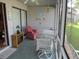 Cozy screened porch with comfortable seating, offering a relaxing outdoor living space at 500 Fairway Village Dr. # 4-F, Myrtle Beach, SC 29588