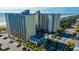 An aerial view of a multi-story condo complex with a fountain, parking, and ocean view at 5300 N Ocean Blvd. # 442, Myrtle Beach, SC 29577