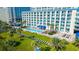 Beautiful grounds of the multi-story condo complex with palm trees, green space, and a large pool at 5300 N Ocean Blvd. # 442, Myrtle Beach, SC 29577
