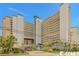 Exterior shot of the Dunes Village Resort showing palm trees, landscaping and the towers at 5300 N Ocean Blvd. # 442, Myrtle Beach, SC 29577
