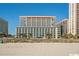 Exterior shot from beach showing condos surrounded by lush landscape and ocean view at 5300 N Ocean Blvd. # 442, Myrtle Beach, SC 29577
