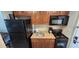 Functional kitchen with dark appliances, wooden cabinets, and granite-style countertops at 5300 N Ocean Blvd. # 442, Myrtle Beach, SC 29577