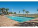 Large pool area with ample lounge seating surrounded by lush palm trees on a sunny day at 5300 N Ocean Blvd. # 442, Myrtle Beach, SC 29577