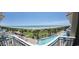 Expansive beach and pool views from the balcony, showcasing palm trees and recreational areas at 5300 N Ocean Blvd. # 442, Myrtle Beach, SC 29577