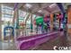 Indoor waterpark featuring slides and colorful aquatic-themed decor for Gathering fun at 5300 N Ocean Blvd. # 442, Myrtle Beach, SC 29577
