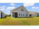 Spacious backyard featuring well-manicured lawn and a screened-in porch at 534 Calhoun Falls Dr., Myrtle Beach, SC 29579