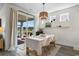 Dining area with modern decor, a stylish light fixture, and a sliding glass door leading to the outdoor space at 534 Calhoun Falls Dr., Myrtle Beach, SC 29579