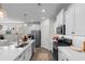 Beautiful modern kitchen boasts stainless steel appliances, a large island with seating, and sleek white cabinetry at 534 Calhoun Falls Dr., Myrtle Beach, SC 29579