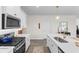 Well-equipped kitchen featuring an island with a sink, modern appliances, and ample white cabinetry at 534 Calhoun Falls Dr., Myrtle Beach, SC 29579