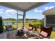 Relaxing screened-in porch overlooking a serene pond, furnished with cozy seating at 534 Calhoun Falls Dr., Myrtle Beach, SC 29579