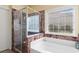 Modern bathroom featuring a glass shower, soaking tub, and elegant marble accents for a luxurious spa-like experience at 5712 Whistling Duck Dr., North Myrtle Beach, SC 29582
