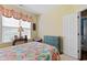 Comfortable bedroom with floral bedding, soft lighting, and a blue dresser at 5712 Whistling Duck Dr., North Myrtle Beach, SC 29582