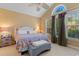 Bright bedroom featuring a vaulted ceiling, colorful bedding, and large windows, creating a comfortable retreat at 5712 Whistling Duck Dr., North Myrtle Beach, SC 29582