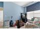 Comfortable bedroom with blue accent wall and colorful coral patterned armchair at 5712 Whistling Duck Dr., North Myrtle Beach, SC 29582