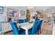 Elegant dining area featuring plush velvet seating, a stylish chandelier, and views of the kitchen at 5712 Whistling Duck Dr., North Myrtle Beach, SC 29582
