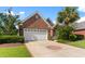 Charming single story brick home with a well manicured lawn, lush landscaping and a two car garage at 5712 Whistling Duck Dr., North Myrtle Beach, SC 29582