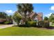 Charming single story brick home with a well manicured lawn, mature landscaping, and a paver driveway at 5712 Whistling Duck Dr., North Myrtle Beach, SC 29582