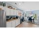 Bright kitchen with white cabinets, granite countertops, and a dining area filled with natural light at 5712 Whistling Duck Dr., North Myrtle Beach, SC 29582