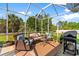 Relaxing screened porch with comfortable wicker furniture and a grill at 5712 Whistling Duck Dr., North Myrtle Beach, SC 29582