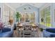 Bright sunroom with ample windows, comfortable seating, and a wooden table, creating a serene and relaxing space at 5712 Whistling Duck Dr., North Myrtle Beach, SC 29582