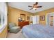 Inviting bedroom featuring soft yellow walls, with ceiling fan, TV on dresser, and a comfortable chair at 601 Hillside Dr. N # 3926, North Myrtle Beach, SC 29582