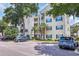 Condo building exterior with light-yellow siding, white trim, green shutters, and palm trees at 601 Hillside Dr. N # 3926, North Myrtle Beach, SC 29582