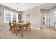Dining room with a wood table set for four under a chandelier and natural light at 601 Hillside Dr. N # 3926, North Myrtle Beach, SC 29582