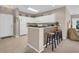 Open kitchen with white cabinets, breakfast bar, and adjacent living area at 601 Hillside Dr. N # 3926, North Myrtle Beach, SC 29582