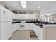 Bright kitchen featuring white cabinets, black countertops, and modern appliances at 601 Hillside Dr. N # 3926, North Myrtle Beach, SC 29582
