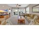 Cozy living room with plush sofa, ceiling fan, and sliding doors to balcony with seating at 601 Hillside Dr. N # 3926, North Myrtle Beach, SC 29582