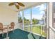 View of screened porch with ceiling fan overlooking the lake and manicured lawn at 601 Hillside Dr. N # 3926, North Myrtle Beach, SC 29582