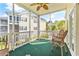 Relaxing screened porch with ceiling fan, outdoor chairs, and views of the manicured landscaping at 601 Hillside Dr. N # 3926, North Myrtle Beach, SC 29582