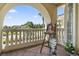 Covered balcony overlooking manicured landscaping and neighborhood, art easel, and arched entryways at 664 Oxbow Dr., Myrtle Beach, SC 29579