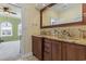 A bathroom including wood cabinets, granite countertops, vanity, and decorative mirror at 664 Oxbow Dr., Myrtle Beach, SC 29579