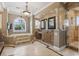 A primary bathroom boasts a soaking tub, custom vanities, and a walk-in shower at 664 Oxbow Dr., Myrtle Beach, SC 29579