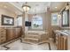 Lavish bathroom features a soaking tub with a TV, tile floors, double vanities, and elegant chandeliers at 664 Oxbow Dr., Myrtle Beach, SC 29579