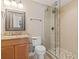 A bathroom including shower with glass doors, vanity with granite countertop, mirror, and toilet at 664 Oxbow Dr., Myrtle Beach, SC 29579