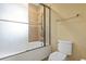 A bathroom featuring a shower-tub combo, glass shower doors, tile accents, and a toilet at 664 Oxbow Dr., Myrtle Beach, SC 29579